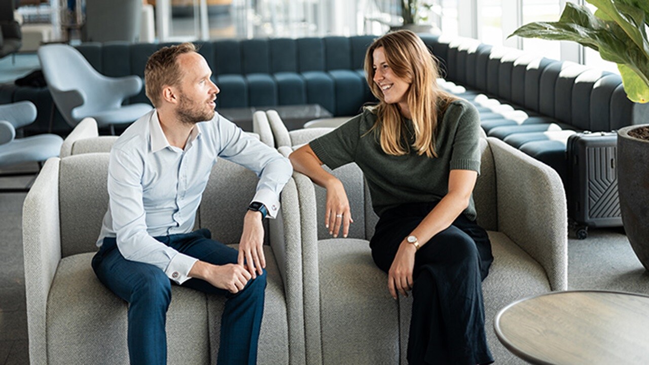 Employees discussing in office lounge