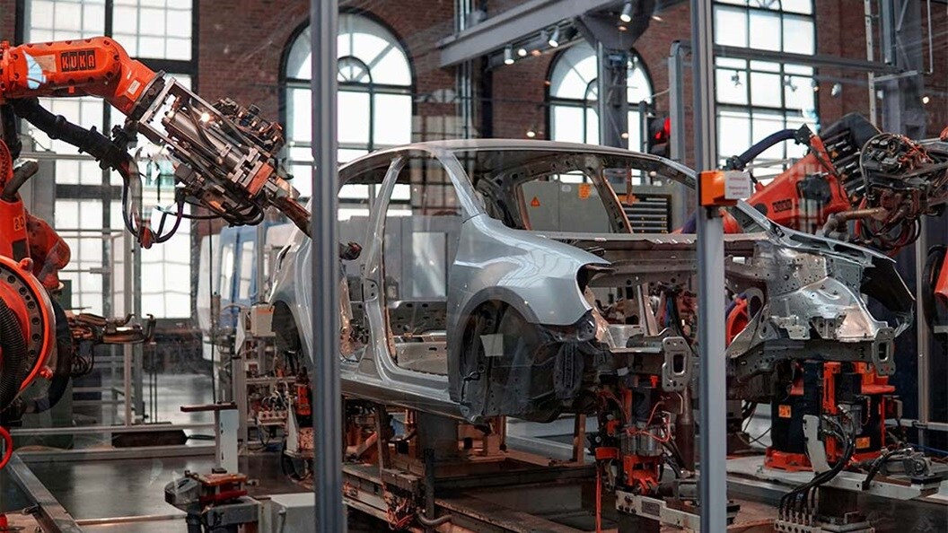 Automotive robots assembling a car on an assembly line.
