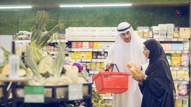 Middle Eastern couple debating what FMCG products to buy from the market
