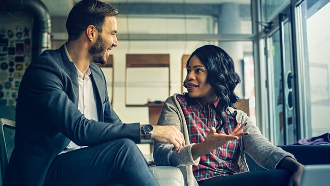 Two employers sitting and discussing and laughing