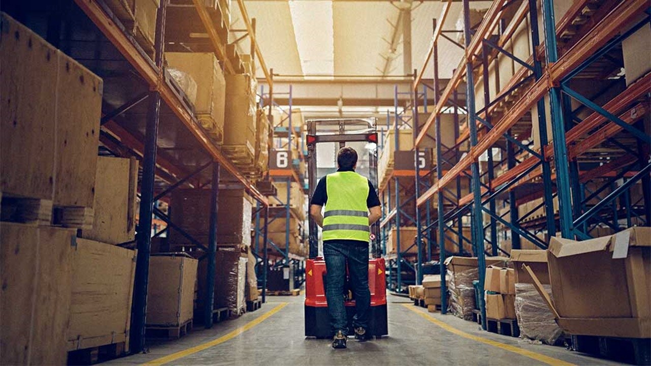 Male with protective vest inside a warehouse