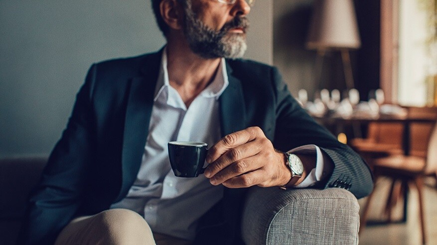 Man sitting with a coffee in hand