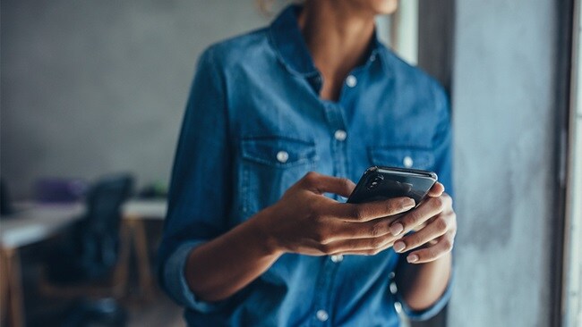 Close up of a set of hands working on a mobile phone 