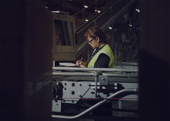 Female employee working on the conveyor belt