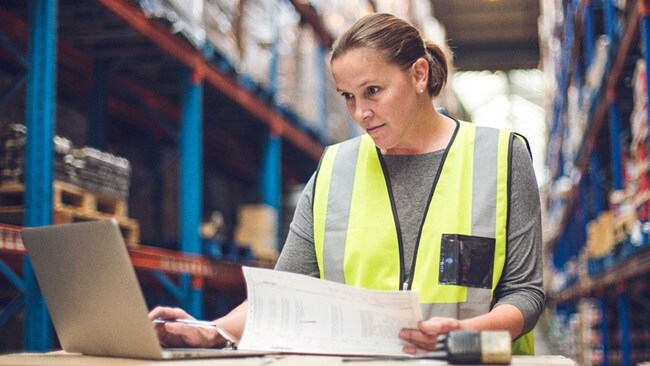 Female employee, wearing yellow safety vest