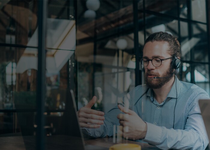 Young businessman at modern office having video call