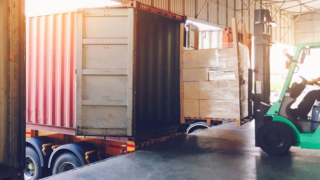 Forklift driver loading cargo shipment