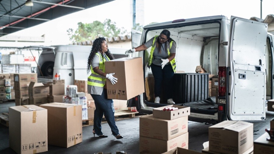 Women employees loading the goods to car