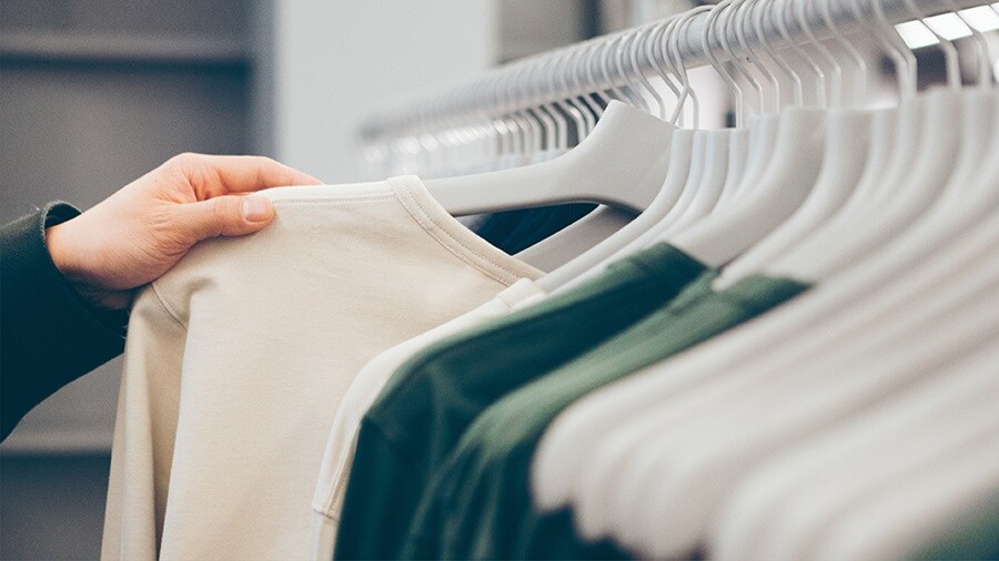 Woman selecting a tshirt from multiple tshirts