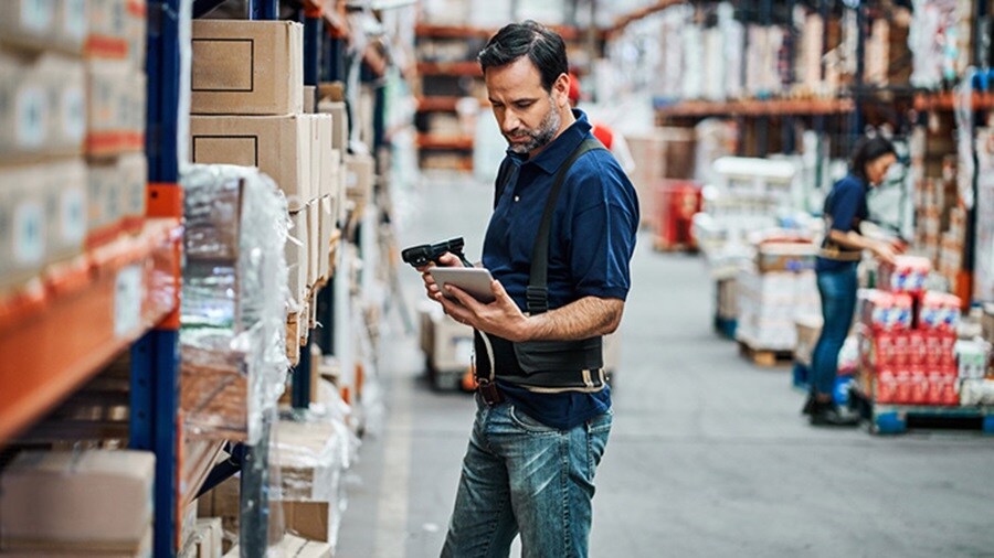 Man scanning parcels at the warehouse using a barcode scanner