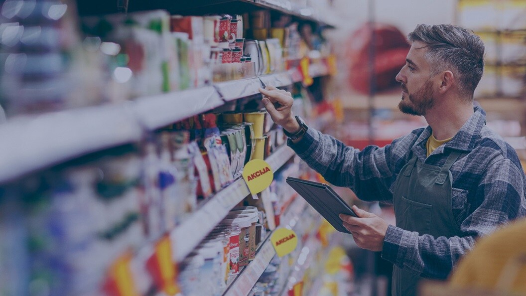 Man cataloguing products at a grocery store
