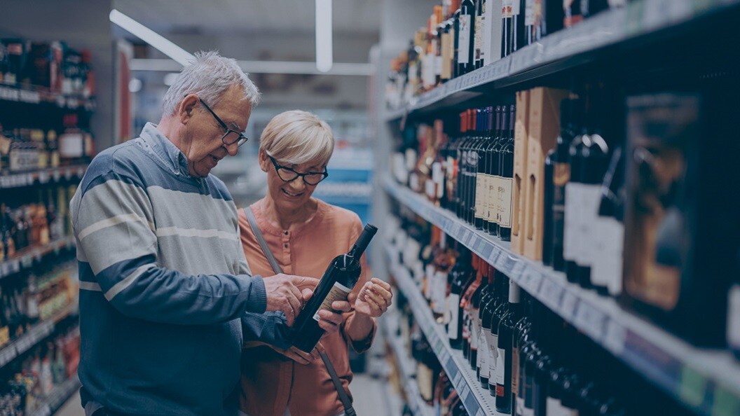 Man and a woman choosing wine in a store
