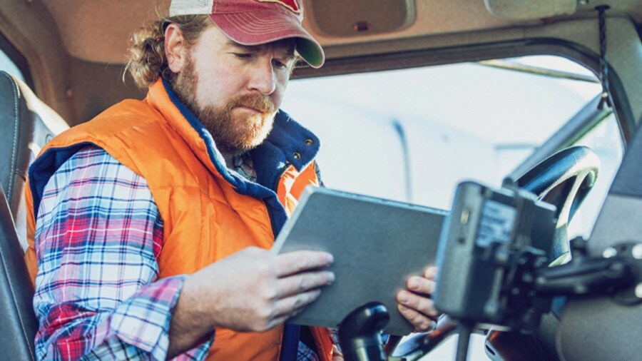 Man looking at a tablet in a truck