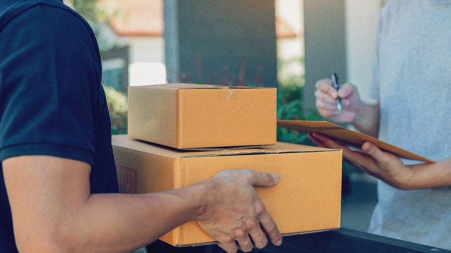 Male delivering a set of boxes to another male