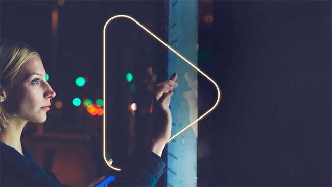 Female clicking on a play button
