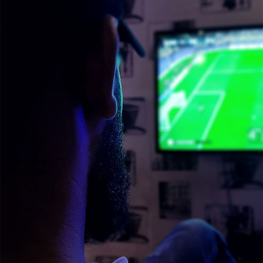 Portrait man watching football on TV
