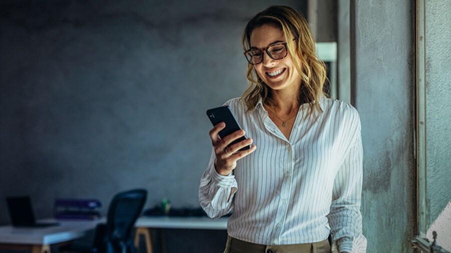 Smiling woman checking her mobile phone