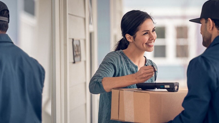 Woman receiving a package from delivery man