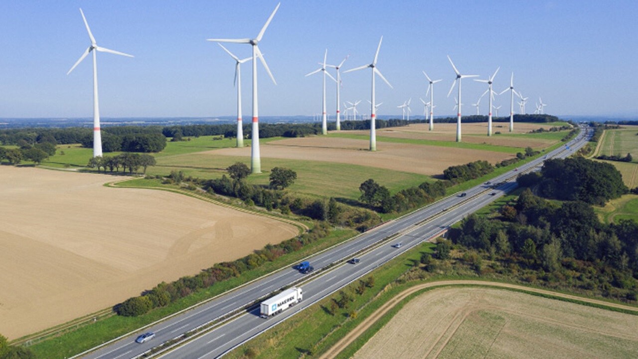 Traffic on road with windmills in background