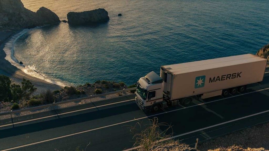 Maersk truck driving along a coastal road