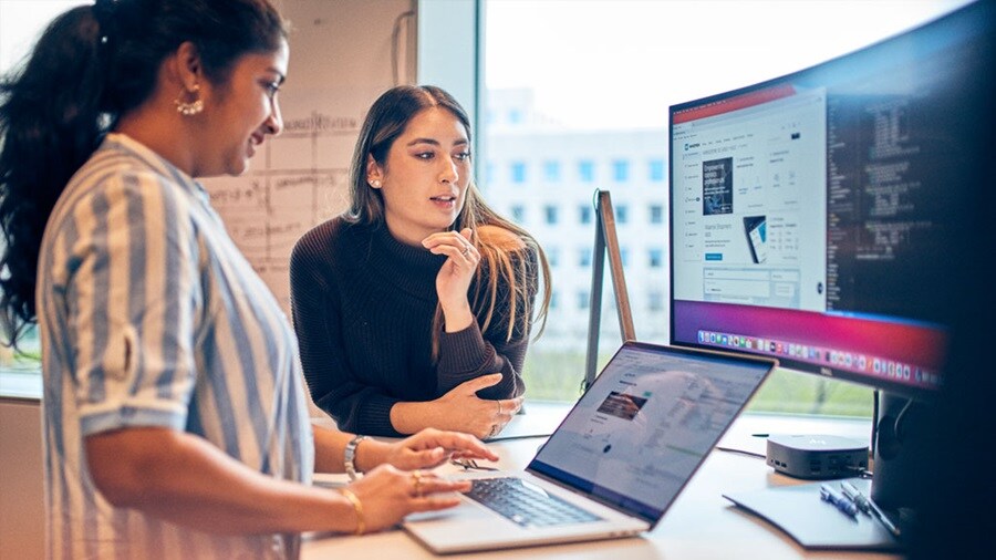 Two female employees looking data