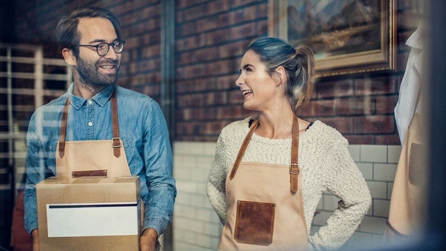 Man and woman wearing aprons