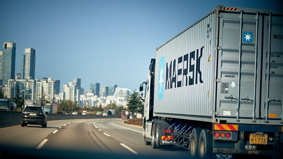 Truck with a Maersk driving into the city.