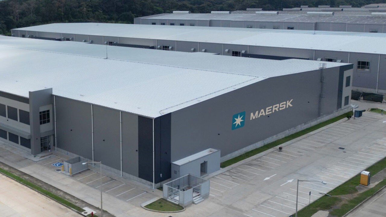 Maersk warehouse facility with large grey buildings and empty parking spaces in Panama Pacifico.