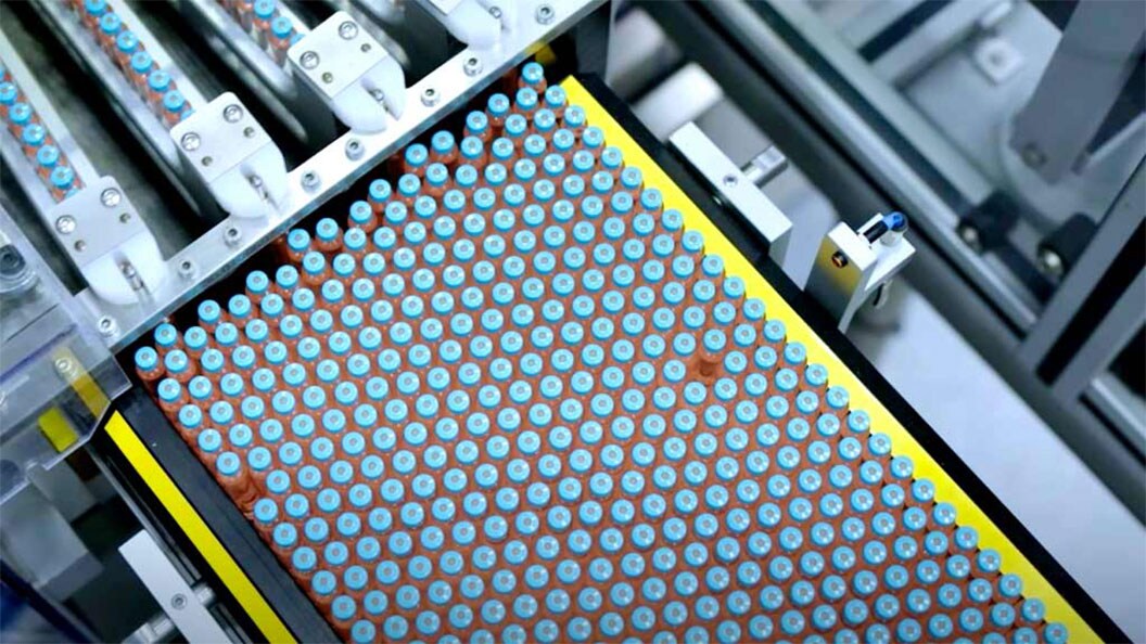 A pharmaceutical machine is assembling a tray of assorted pills for distribution.