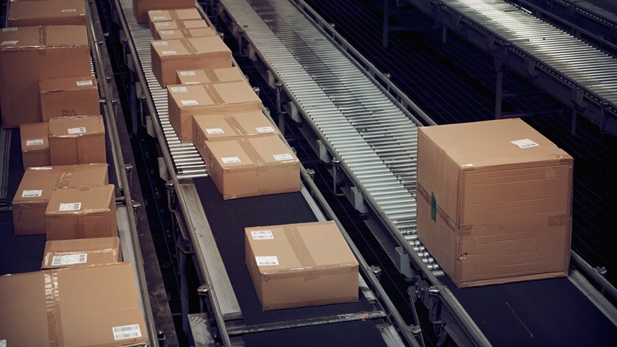 Ecommerce parcels on a conveyor belt in a warehouse