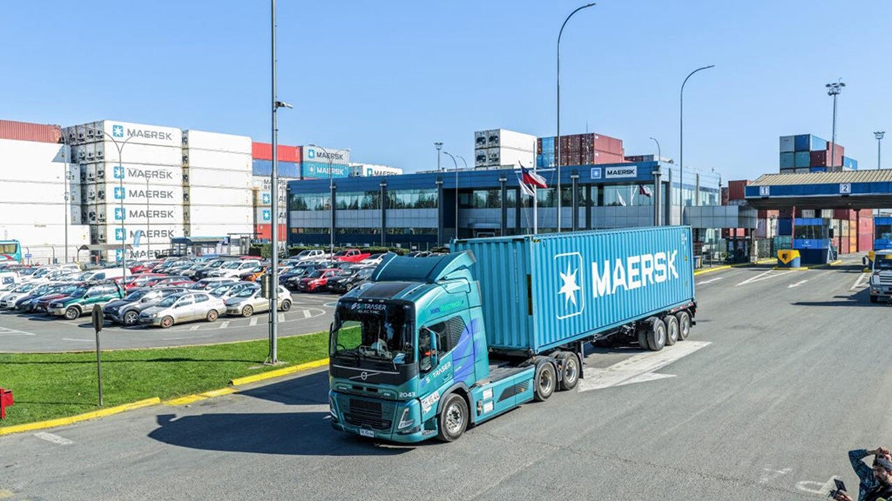 Maersk blue container leaving depot on truck