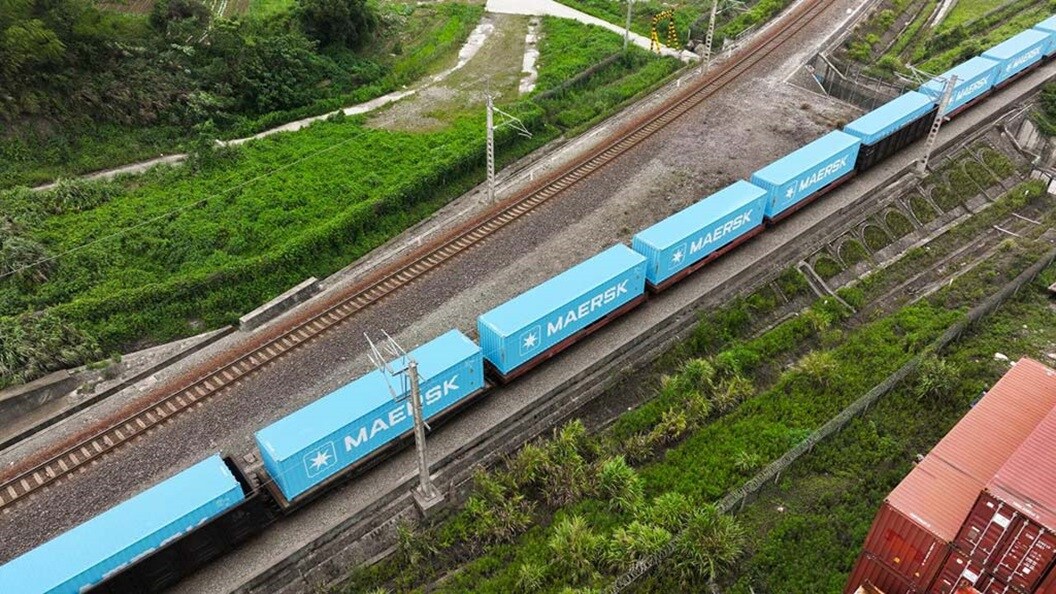 Blue Maersk containers being transported by rail.