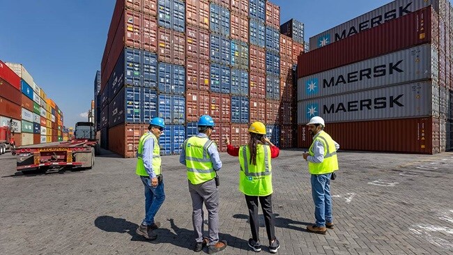 Maersk employees discussing infront of containers