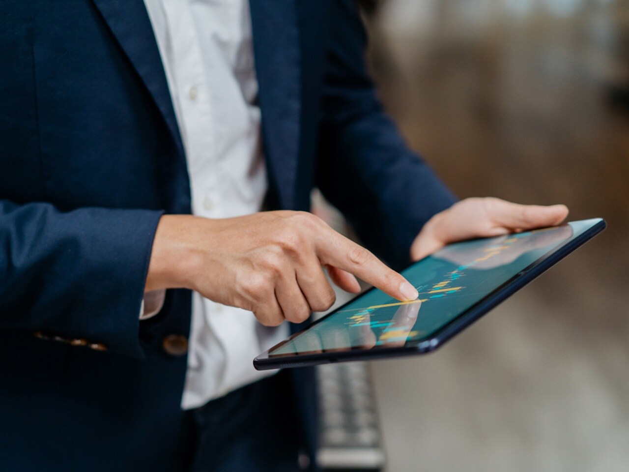 A person using a digital tablet, engaging with the screen.