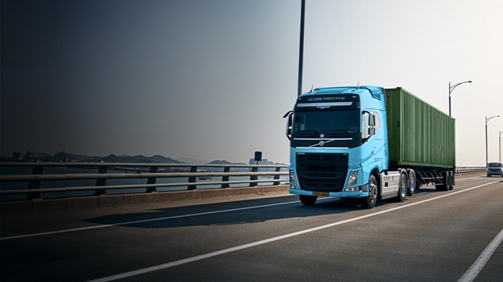 Aerial view of a large intermodal container yard with stacked shipping containers in various colors and brands.