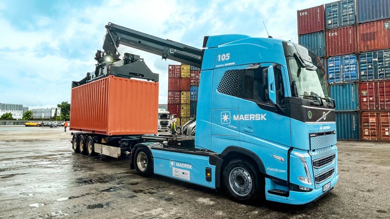 Maersk truck transporting a shipping container at a container terminal.